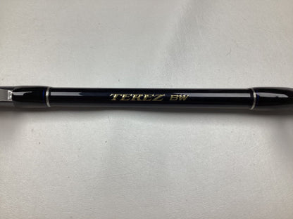 A Shimano Terez BW Full Roller Uni Butt Rod, 78" in black and silver with "TEREZ BW" inscribed in gold on a light gray background—ideal for our Rod and Reel Trade-In Program. Used but in mint condition.