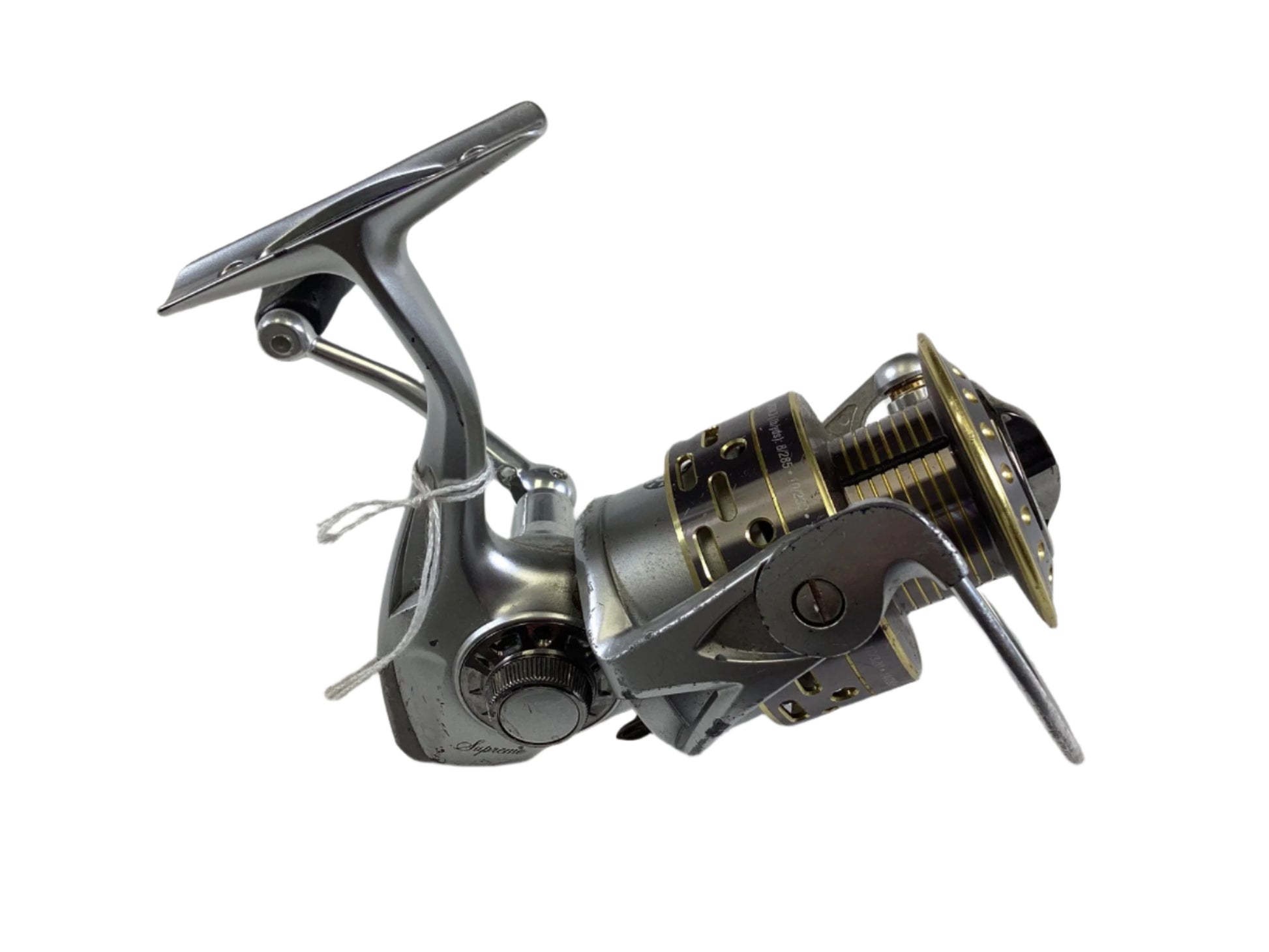 Pflueger Supreme SUPSP40 spinning reel in silver and gold with wooden knob, smooth handle, and intricate detailing. This used gear is in fair condition with a visible winding mechanism, ideal for our Rod and Reel Trade-In Program for store credit.