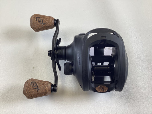 The 13 Fishing Concept A3 Gen II CA3-8.1-LH 8.1:1 LH, a used black casting reel with two brown cork handles in excellent condition, is on display for enthusiasts considering our Rod and Reel Trade-In Program for store credit.