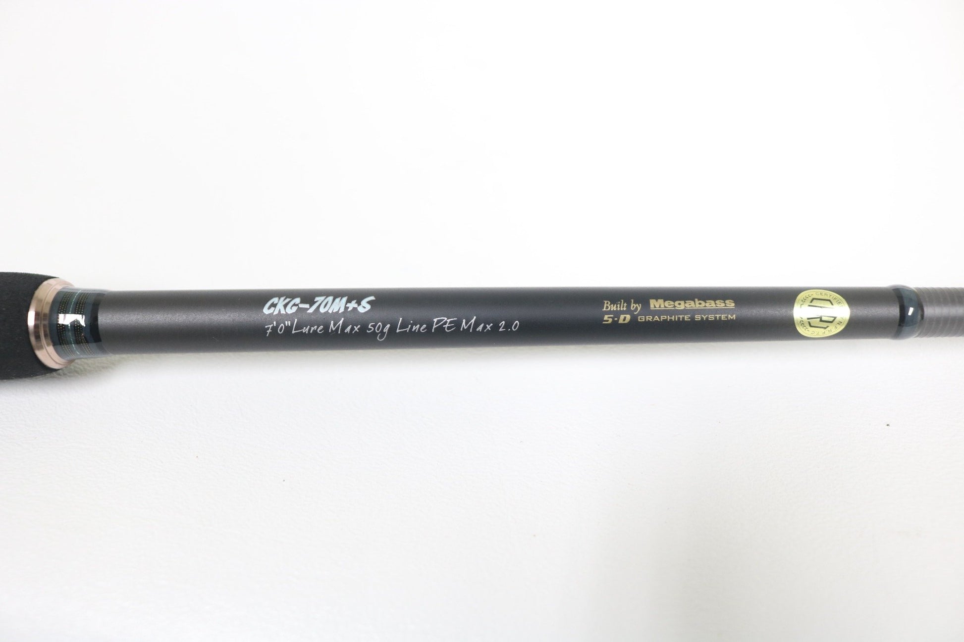 Close-up of a Megabass Cookai Gulf CKG-70M+S 7'0" spinning rod with a black handle and graphite finish. Text: "Lure Max 50g, Line PE Max 2.0" and "Built by Megabass 5D Graphite System." Perfect for our Rod and Reel Trade-In Program—upgrade your gear today! White background.