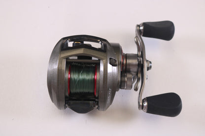 The Abu Garcia Revo ALT 6.4:1 RH, a used casting reel in very good condition, features a silver finish with a black handle and spool wound with green line. It's ideal for our Rod and Reel Trade-In Program against a plain white backdrop.