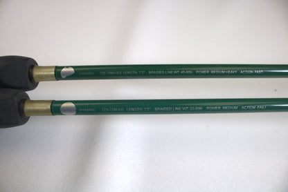 Close-up of two green Shimano Terez Evergreen rod handles showing specifications: "Shimano," lengths "7'2"," braided line weights "40-65lb" and "20-50lb," actions "Fast" and "Medium Heavy," and featuring black grips.